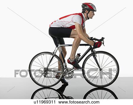Bicyclist mounted on bicycle profile View Large Photo Image Stock Image - Bicyclist mounted on bicycle profile. Fotosearch