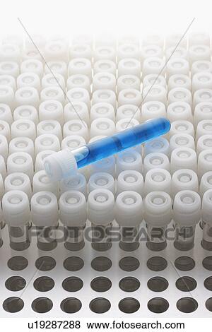 Stock Photo - Blue test tube lying on empty test tubes. Fotosearch