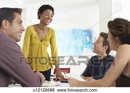 Business colleagues in office meeting View Large Photo Image Stock Photo - Business colleagues in office meeting. Fotosearch