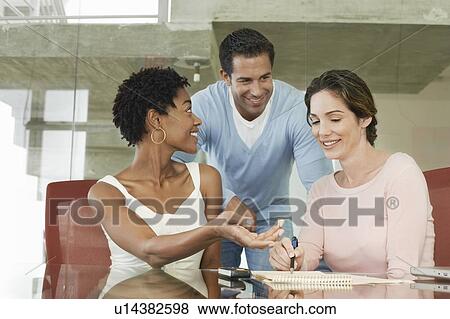 Business colleagues in office meeting View Large Photo Image Stock Photo - Business colleagues in office meeting. Fotosearch