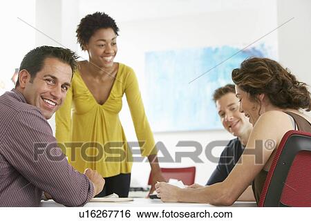 Business colleagues in office meeting View Large Photo Image Stock Photograph - Business colleagues in office meeting. Fotosearch