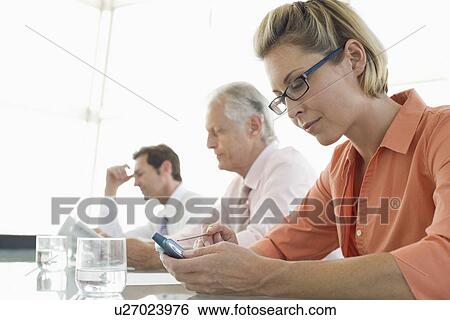 Stock Photograph - Business colleagues working in conference room. Fotosearch