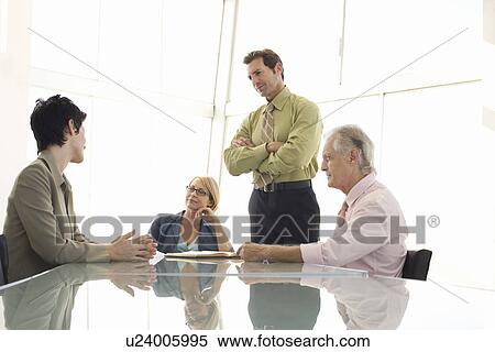 Business colleagues working in conference room View Large Photo Image Stock Photography - Business colleagues working in conference room. Fotosearch