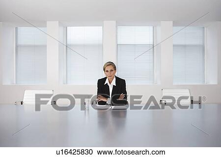 Stock Image - Business Executive Sitting in Boardroom. Fotosearch