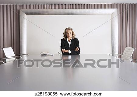 Stock Photography - Business Executive Sitting in Boardroom. Fotosearch