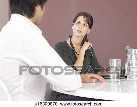 Business man and woman having meeting View Large Photo Image Stock Photo - Business man and woman having meeting. Fotosearch