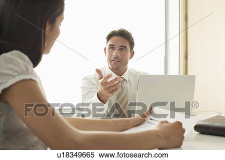 Business man and woman in meeting View Large Photo Image Stock Photography - Business man and woman in meeting. Fotosearch