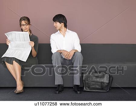 Stock Photo - Business man and woman on sofa. Fotosearch