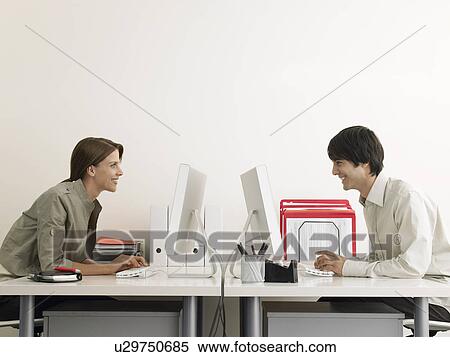 Business Man and Woman Working on Computers Face to Face View Large Photo Image Stock Photography - Business Man and Woman Working on Computers Face to Face. Fotosearch