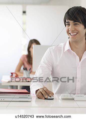 Stock Image - Business man at desk. Fotosearch