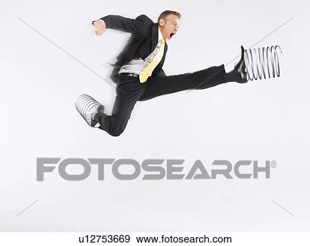 Stock Photo - Business man jumping with springs on feet. Fotosearch