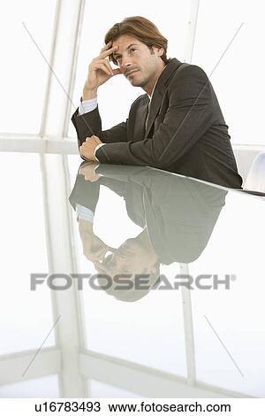 Business man sitting at conference table View Large Photo Image Stock Image - Business man sitting at conference table. Fotosearch