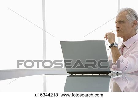 Business man using laptop in conference room View Large Photo Image Stock Photo - Business man using laptop in conference room. Fotosearch