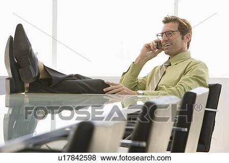 Business man using mobile phone in conference room View Large Photo Image Stock Photo - Business man using mobile phone in conference room. Fotosearch