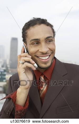 Business man using mobile phone outdoors View Large Photo Image Stock Photo - Business man using mobile phone outdoors. Fotosearch