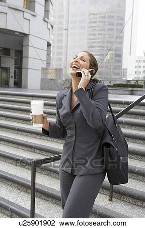 Business woman laughing on mobile phone in city View Large Photo Image Stock Image - Business woman laughing on mobile phone in city. Fotosearch