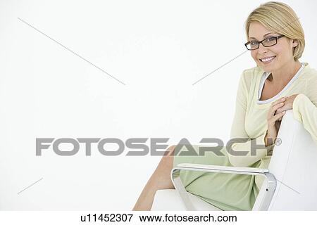 Business woman sitting in chair portrait View Large Photo Image Stock Photo - Business woman sitting in chair portrait. Fotosearch