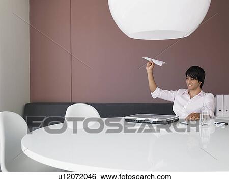 Businessman Aiming Paper Airplane in Modern Office View Large Photo Image Stock Photograph - Businessman Aiming Paper Airplane in Modern Office. Fotosearch