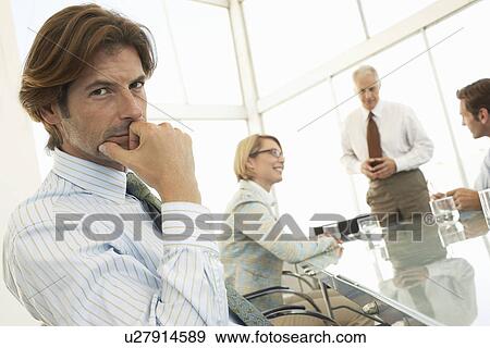 Stock Photo - Businessman in conference meeting portrait. Fotosearch