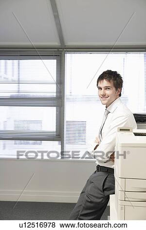 Businessman leaning against office photocopier portrait View Large Photo Image Stock Photo - Businessman leaning against office photocopier portrait. Fotosearch