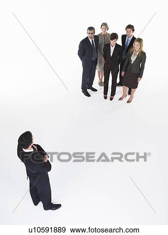 Businessman looking at group View Large Photo Image Stock Photo - Businessman looking at group. Fotosearch