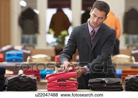 Businessman shopping in clothes store View Large Photo Image Stock Photo - Businessman shopping in clothes store. Fotosearch