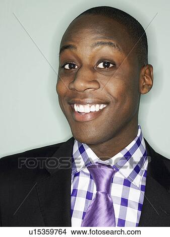 Picture - Businessman smiling in studio head and shoulders. Fotosearch