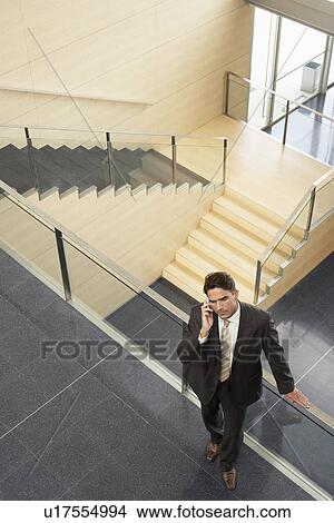 Picture - Businessman Talking on Cell Phone elevated view. Fotosearch