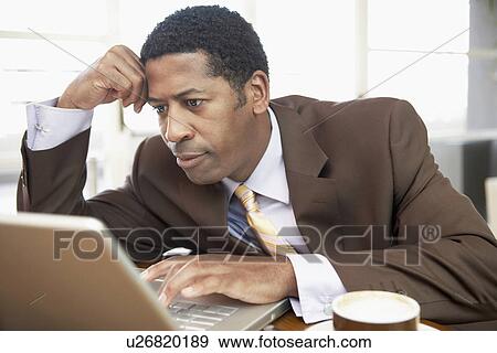 Businessman Using Laptop hand on head head and shoulders View Large Photo Image Stock Photo - Businessman Using Laptop hand on head head and shoulders. Fotosearch