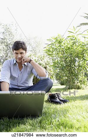 Businessman Using Laptop in Park View Large Photo Image Picture - Businessman Using Laptop in Park. Fotosearch
