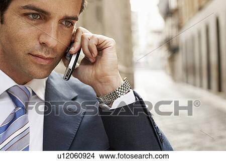 Picture - Businessman using mobile phone close-up.. Fotosearch