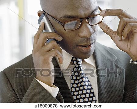 Businessman using mobile phone indoors (close-up) View Large Photo Image Stock Photo - Businessman using mobile phone indoors (close-up). Fotosearch