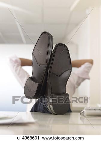 Businessman with Feet Up on Desk obscured face View Large Photo Image Stock Image - Businessman with Feet Up on Desk obscured face. Fotosearch