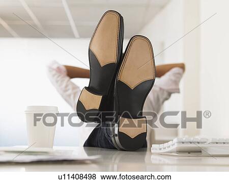 Businessman with Feet Up on Desk obscured face View Large Photo Image Stock Photo - Businessman with Feet Up on Desk obscured face. Fotosearch
