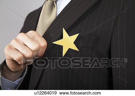 Businessman with gold star on suit close-up View Large Photo Image Stock Photo - Businessman with gold star on suit close-up. Fotosearch