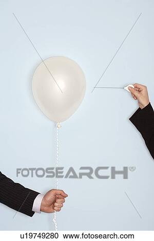 Businessmen holding and popping balloon close-up of hands View Large Photo Image Stock Image - Businessmen holding and popping balloon close-up of hands. Fotosearch
