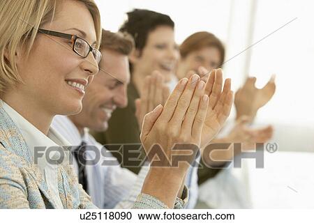 Stock Image - Businesspeople clapping in conference meeting. Fotosearch