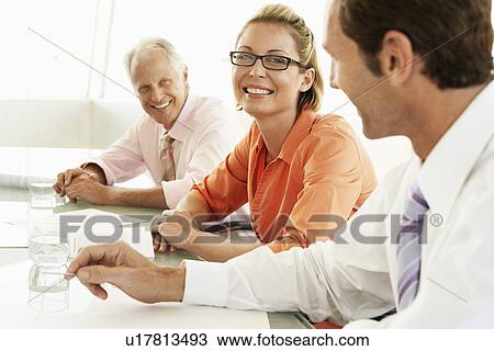 Businesspeople in conference meeting smiling View Large Photo Image Stock Image - Businesspeople in conference meeting smiling. Fotosearch