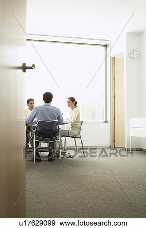 Stock Photo - Businesspeople in Meeting in modern office. Fotosearch