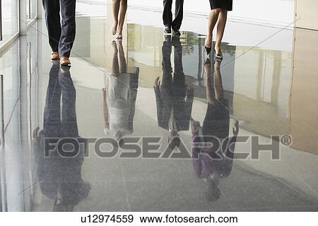 Businesspeople Walking on corridor low section View Large Photo Image Stock Photo - Businesspeople Walking on corridor low section. Fotosearch