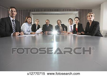 Stock Photography - Businesspeople Watching Presentation in Conference Room. Fotosearch