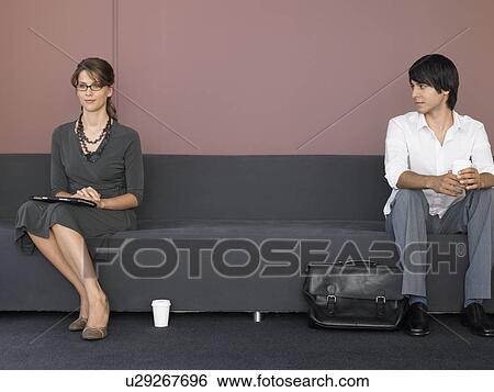 Stock Photograph - Businesswoman and Businessman in Office Lobby. Fotosearch