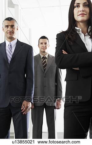 Stock Image - Businesswoman and two businessmen portrait. Fotosearch