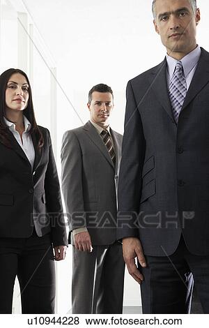 Stock Photo - Businesswoman and two businessmen portrait. Fotosearch