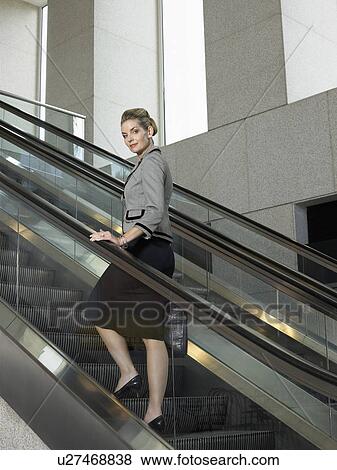 Businesswoman on escalator (portrait) View Large Photo Image Stock Photo - Businesswoman on escalator (portrait). Fotosearch