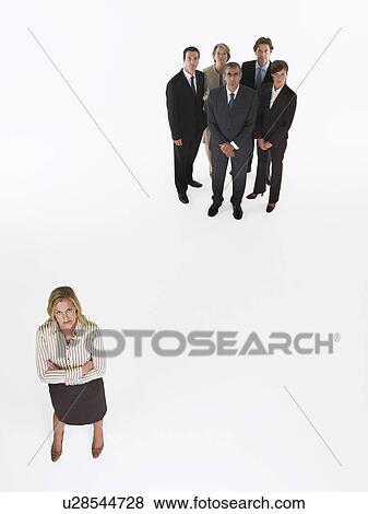 Businesswoman standing apart from group View Large Photo Image Stock Photo - Businesswoman standing apart from group. Fotosearch