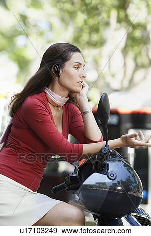 Businesswoman Using Cell Phone on Moped View Large Photo Image Stock Photo - Businesswoman Using Cell Phone on Moped. Fotosearch