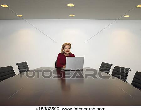 Businesswoman using laptop in conference room View Large Photo Image Stock Image - Businesswoman using laptop in conference room. Fotosearch