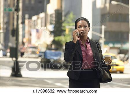 Businesswoman using mobile phone in street View Large Photo Image Stock Image - Businesswoman using mobile phone in street. Fotosearch