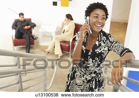 Businesswoman using mobile phone on stairs View Large Photo Image Stock Photo - Businesswoman using mobile phone on stairs. Fotosearch